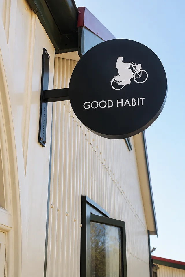 The round Good Habit bicycle sign outside the cafe